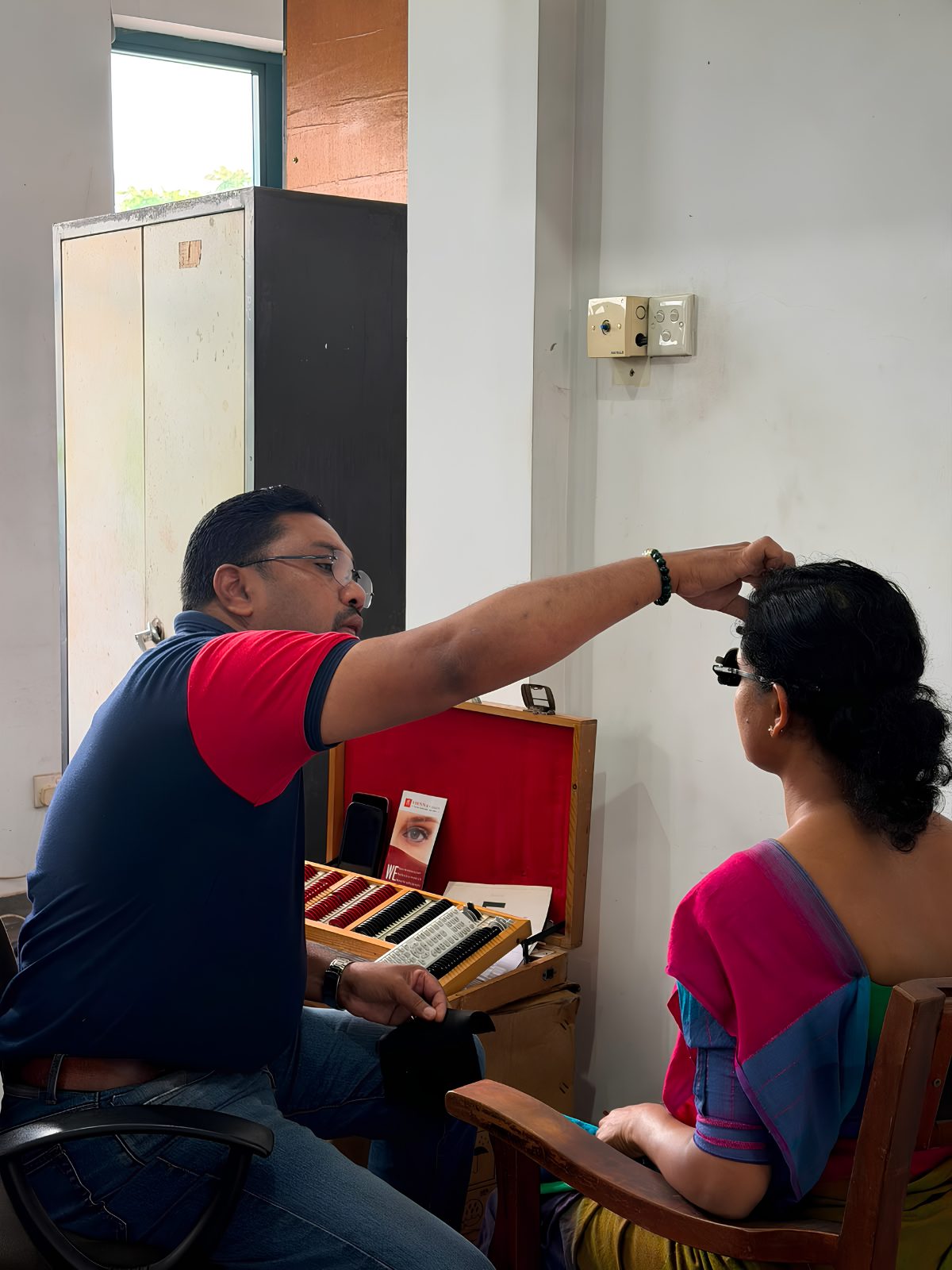 Vienna Vision optometrist fitting trial lenses during a professional eye test